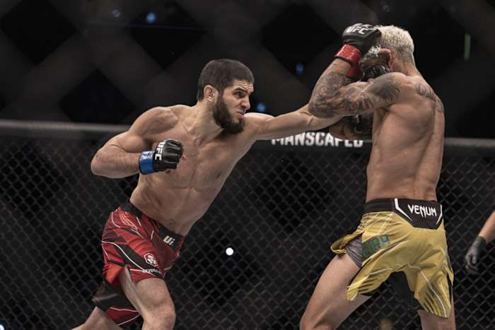 Islam Makhachev in action against Charles Oliveira for their UFC 280 championship fight.